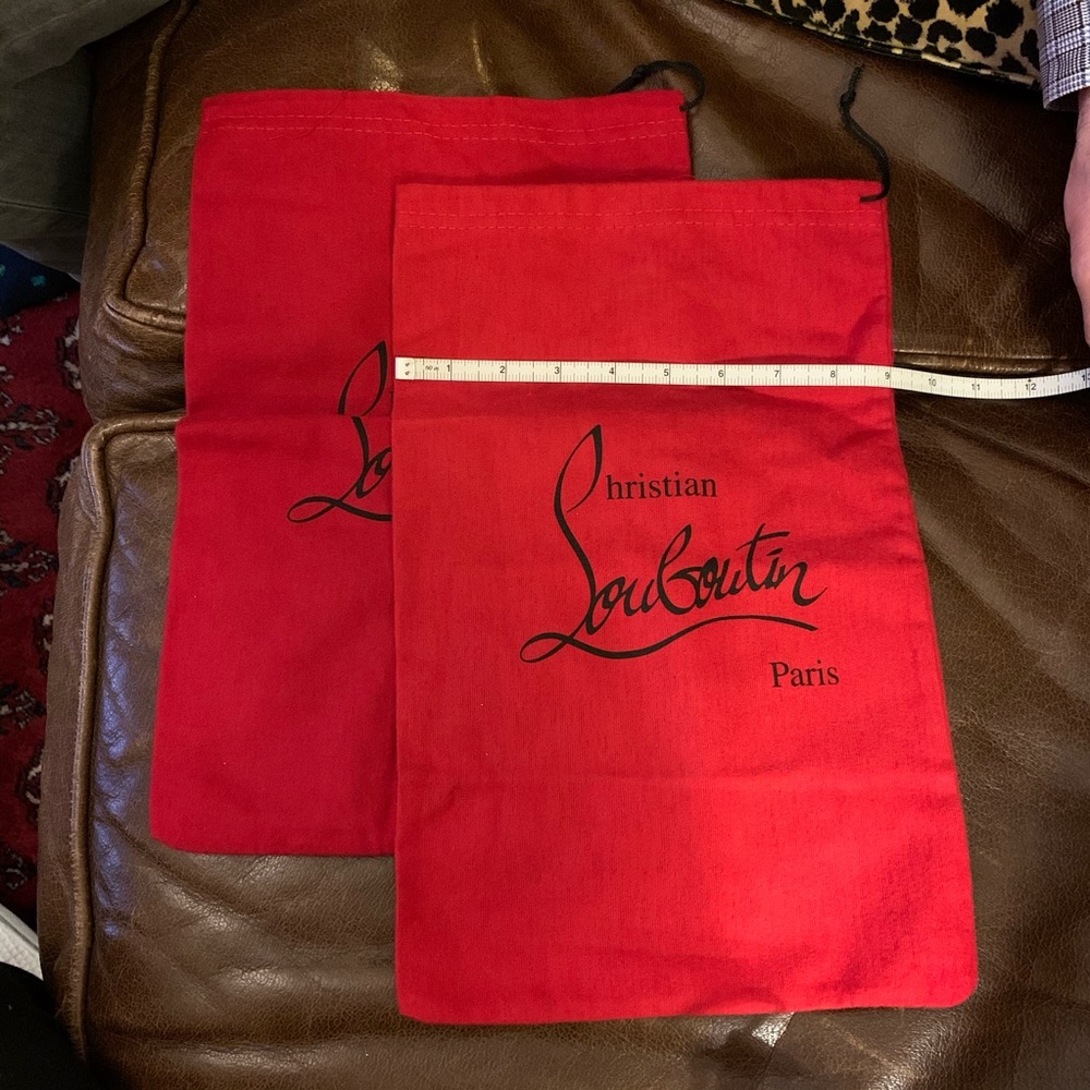 Pair of red Christian loubitons shoes dust bags